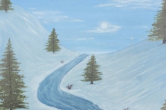 Picture of a river flowing throw snowy landscape with pine trees and a blue sky.